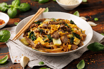 Thai Pad See Ew with beef, eggs, vegetables and rice noodles.