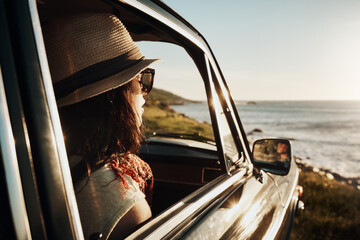 Naklejka premium Road trip, morning and woman in car by ocean on holiday, vacation and summer weekend by window. Travel, relax and person in vehicle by seaside for transport, journey and adventure drive in nature