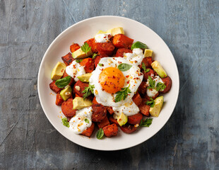 Sweet Potato and Chorizo Hash with egg, avocado and herbs.