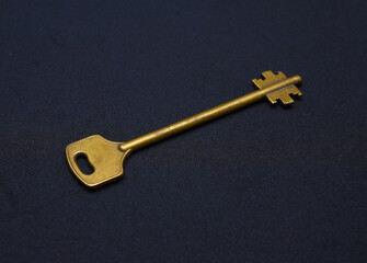 A copper key on a black background. The key to the front door.