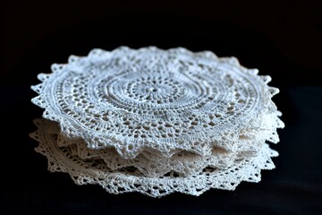 A collection of intricately crocheted white doilies, showcasing delicate patterns and craftsmanship, perfect for elegant home decor.