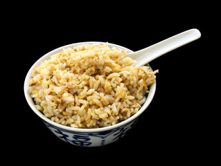 A bowl of Chinese egg fried rice on a black background