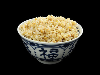 A bowl of Chinese egg fried rice on a black background