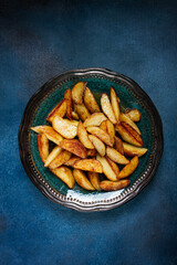 fried potato slices, on a plate, top view, homemade, no people,