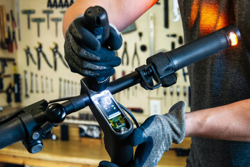 Repairing an electric scooter in a workshop. A close-up shot of a master disassembling a scooter with an electric screwdriver. © Konstantin
