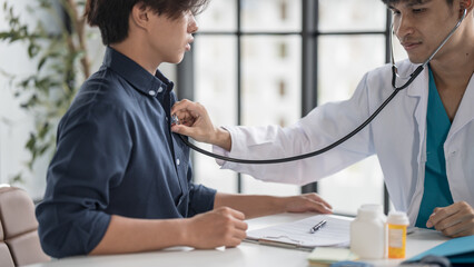 Medical Exam Doctor Monitoring Patient's Pulse Rate