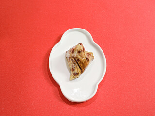 Traditional Chinese Dragon Boat Festival food dumplings and tea on a red table