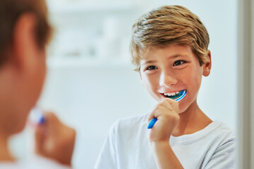 Boy child, mirror or toothpaste in bathroom for cleaning teeth, oral care or hygiene in home. Male...