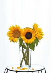 Fototapeta premium Decorative bouquet of sunflowers in a vase on a glass table