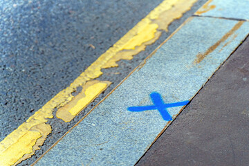 replacing a curb marked with a blue cross