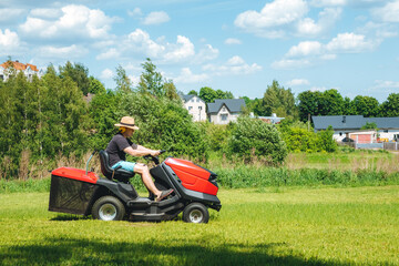 Man on lawn tractor mowing lawn on backyard. The red rider. The lawnmower tractor. High quality 4k footage