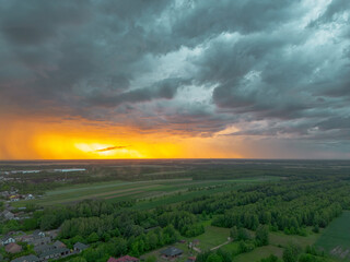 Rural area illuminated by last rays before storm arrives