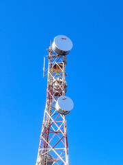 Communication tower with antennas prepared for mobile phones and internet under a clear blue sky