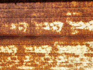 A close-up of an old rusty abandoned garage gate. Industry style, textured wallpaper. Backdrop of grungy warehouse gate. Copy text space