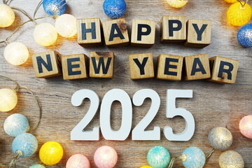 Happy New Year 2025 years number with LED cotton balls decoration top view on wooden background