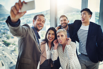 Playful, business people and smile with selfie in office for comedy, partnership and online update. Employees, emoji and HR with digital photography for onboarding, funny and memory of recruitment