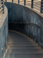 Downstairs to dark tunnel. Perspective image. Black walls.