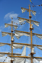 close-up view of the intricate rigging, masts, and sails of a tall ship © Mikhail Olykainen