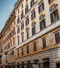 Textured colourful facade of old building in Rome, Italy.