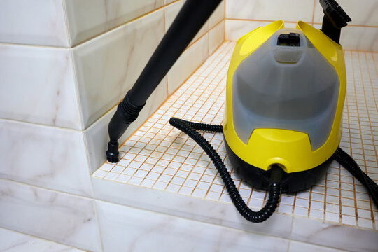 Professional steam cleaner removes grime from shower cabin grout, leaving it clean and sanitized. Restores grout to original white color, making shower sparkle.