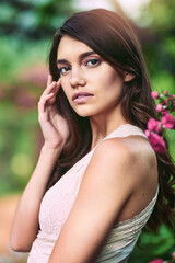 Fototapeta premium Woman, portrait and garden with fantasy, eco fashion and flowers with confidence outdoor. Spring, park and elegance in forest and woods with green, sustainable clothing and glamour style in nature