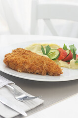 Cutlet with mashed potatoes on a white plate. Dinner