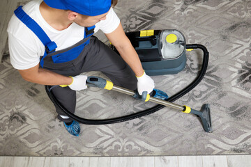 A top view image featuring a cleaning company worker in a specialized uniform and protective gear,...