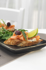 Bruschetta with salmon. Whole grain bread with salmon, cheese and a slice of lemon