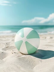 Obraz premium Close Up of a light green and white Beach Ball on sandy Beach. Summer Vacation Wallpaper