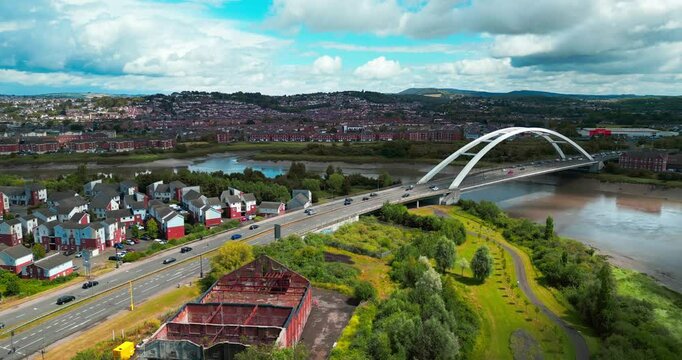 Newport, Wales  River Usk, City bridge, M48 road and surrounding residential areas of the city. Summer time.  panoramic video from a drone