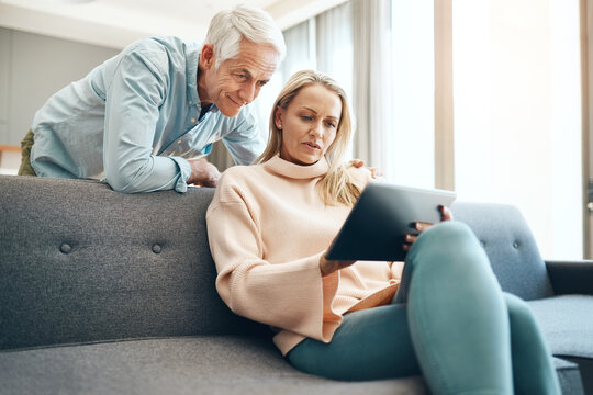 Tablet, internet and mature couple on couch with asset management research, planning and investment in home. Lounge sofa, man and woman with tech for life insurance admin, online faq and finance news