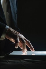 A human businessman controls and interacts with AI using his hand and fingers in a futuristic environment