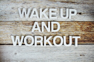 Wake up and Workout alphabet letters on wooden background