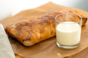 sweet home made pastry bakery made from puff pastry with a crispy crust and a glass of milk. homemade hot cakes