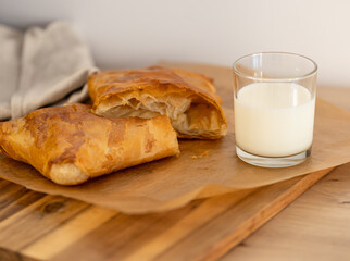 sweet home made pastry bakery made from puff pastry with a crispy crust and a glass of milk. homemade hot cakes