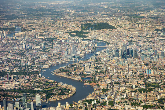 High aerial view of downtown city of London, with river Thames, the Shard, Tower bridge, HMS Belfast and may buildings, squares, offices. embankment, taken from airplane