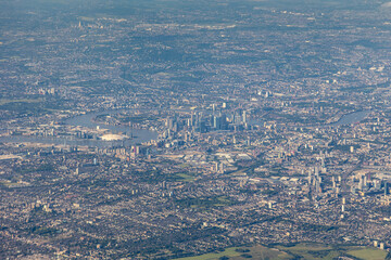 High aerial view of downtown city of London, with river Thames, the Shard, Tower bridge, HMS Belfast and may buildings, squares, offices. embankment, taken from airplane