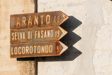 Old vintage signs or directions towards Taranto, Selva di Fasano and Locorotondo, bigger cities in...