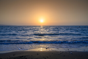 Fototapeta premium Orange sunset over the sea