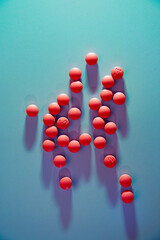 Group of pain pills on a blue background