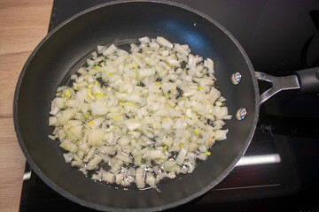 Finely chopped onions in a preheated frying pan with the sludge. Cooking process - Grilling of milled onions into barley