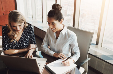 Meeting, laptop and businesswomen with notebook in office for feedback, review or explaining. Writing, recruitment agency and employees with training for learning, coaching or planning project