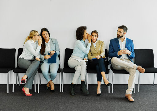 man woman businesswoman business chair sitting waiting businessman candidate recruitment office gender discrimination  job young interview workplace harassment gossip secret rumor