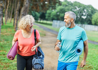 Fototapeta premium woman man couple happy mature together active fit fitness park outdoor healthy talking leisure park love old nature bonding middle aged exercise mat yoga pilates