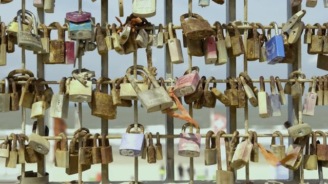 A fence full of locks with peoples messages