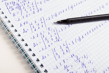 Solving mathematical analysis exercises. The system of equations. Notebook and pen