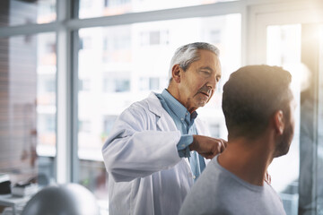 Obraz premium Doctor, man and patient for hand inspection of wrist checkup, arthritis and exam for diagnosis assessment. Medical, people and joint pain from accident, nerve problem and healing arm for wellness