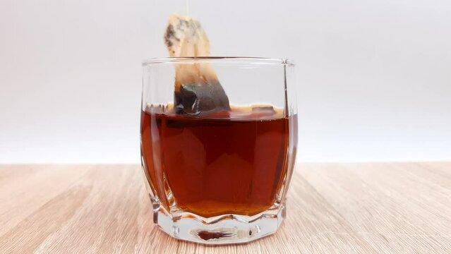 Brewing bagged black tea. Black tea in a bag, tea drinking.