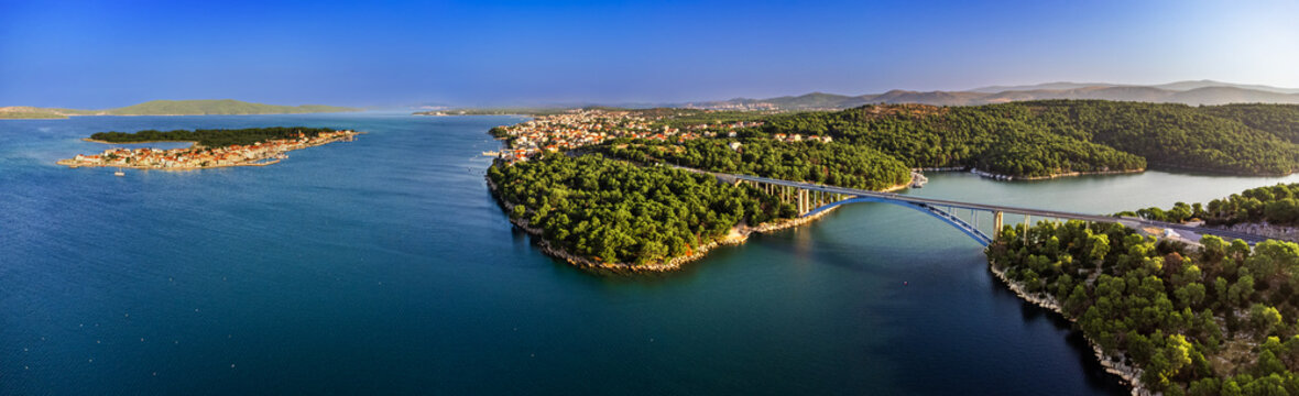Krapanj, Croatia - Aerial panoramic view of Morinje bridge (Morinjski most) on a sunny summer morning with island of Krapanj and Brodarica town at background with clear blue sky