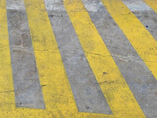 Fototapeta premium A yellow diagonal grid on the asphalt